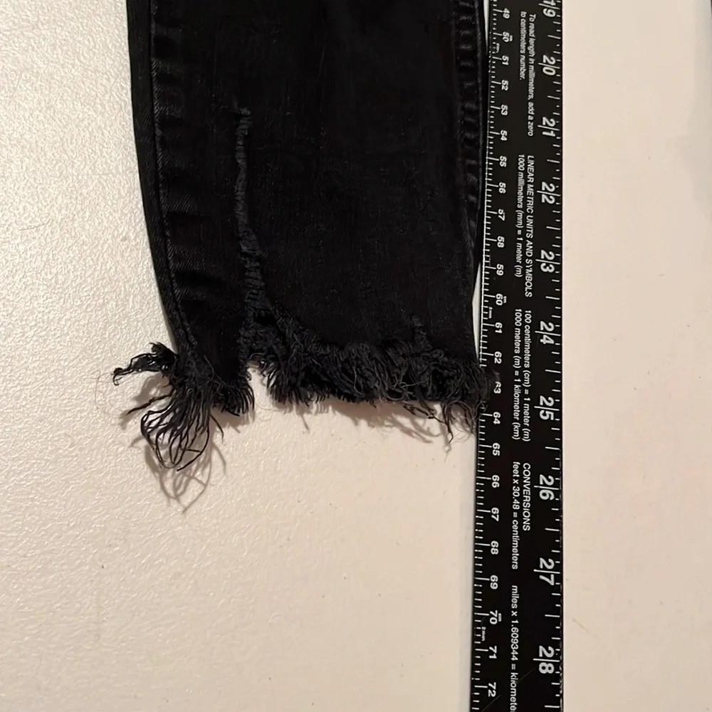Free People size 27 Black Wash skinny jeans distressed with raw hem